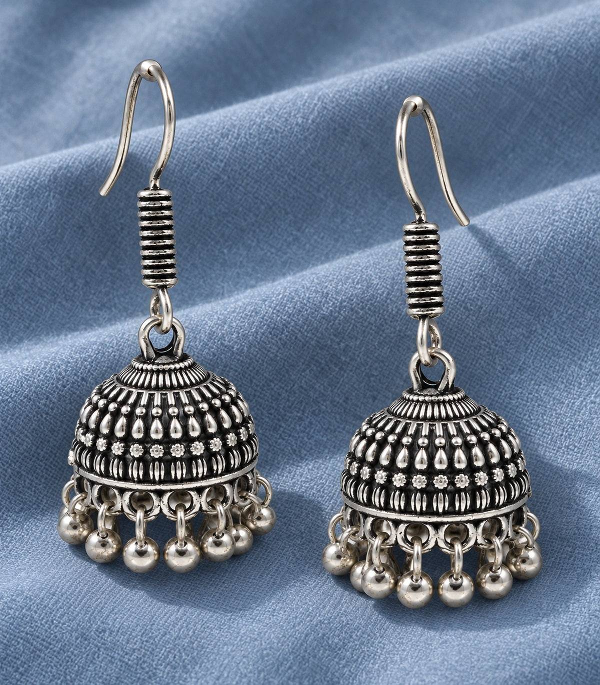 JIMIKI Oxidized Silver Rosette Teardrop Jhumka Earrings - styled flatlay of the matching earrings #color_oxidized-silver