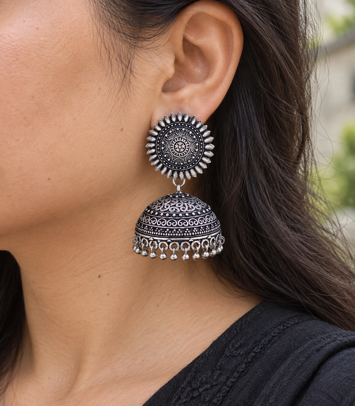JIMIKI Oxidized Silver Sunburst Scroll Dome Jhumka Earrings - close-up of the earring worn #color_oxidized-silver