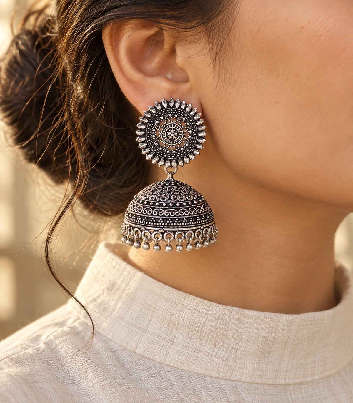 JIMIKI Oxidized Silver Sunburst Scroll Dome Jhumka Earrings - styled model wearing the earring #color_oxidized-silver