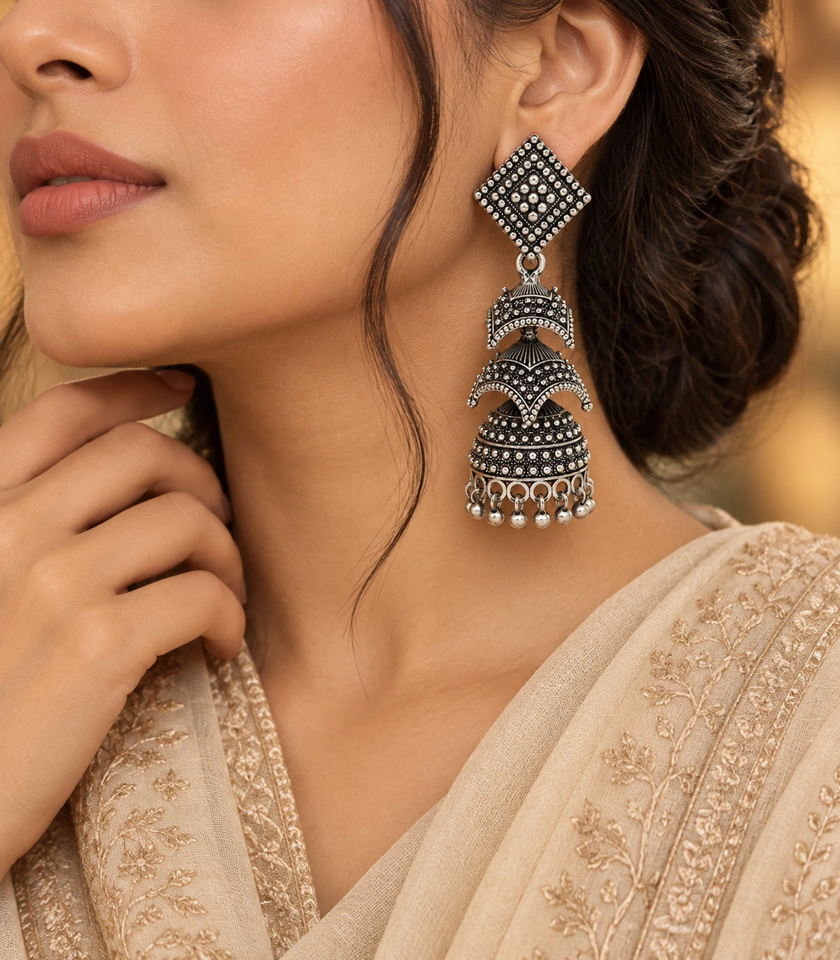 JIMIKI Oxidized Silver Tiered Chevron Jhumka Earrings - editorial styling with cream clothing #color_oxidized-silver