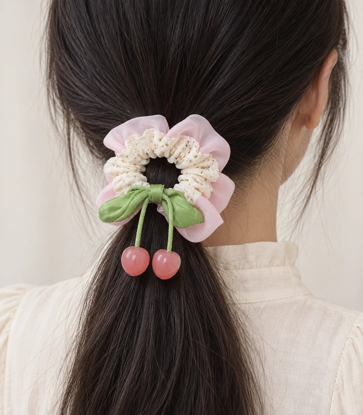 JIMIKI Lace Scrunchie With Cherry Charms in Pale Pink, model wearing view #color_pale pink