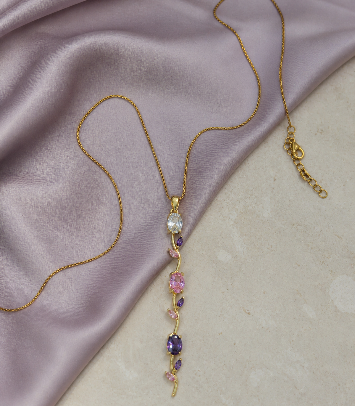 Pastel Leaf Vine Pendant Necklace in an editorial flat lay