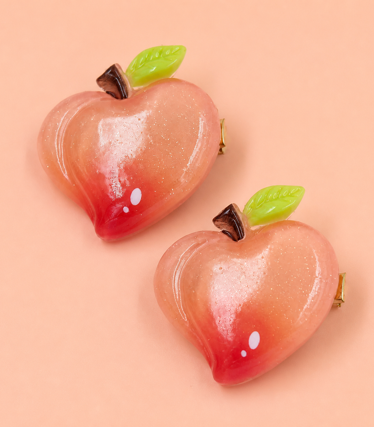 Peach Apple Barrette Pair editorial flat lay