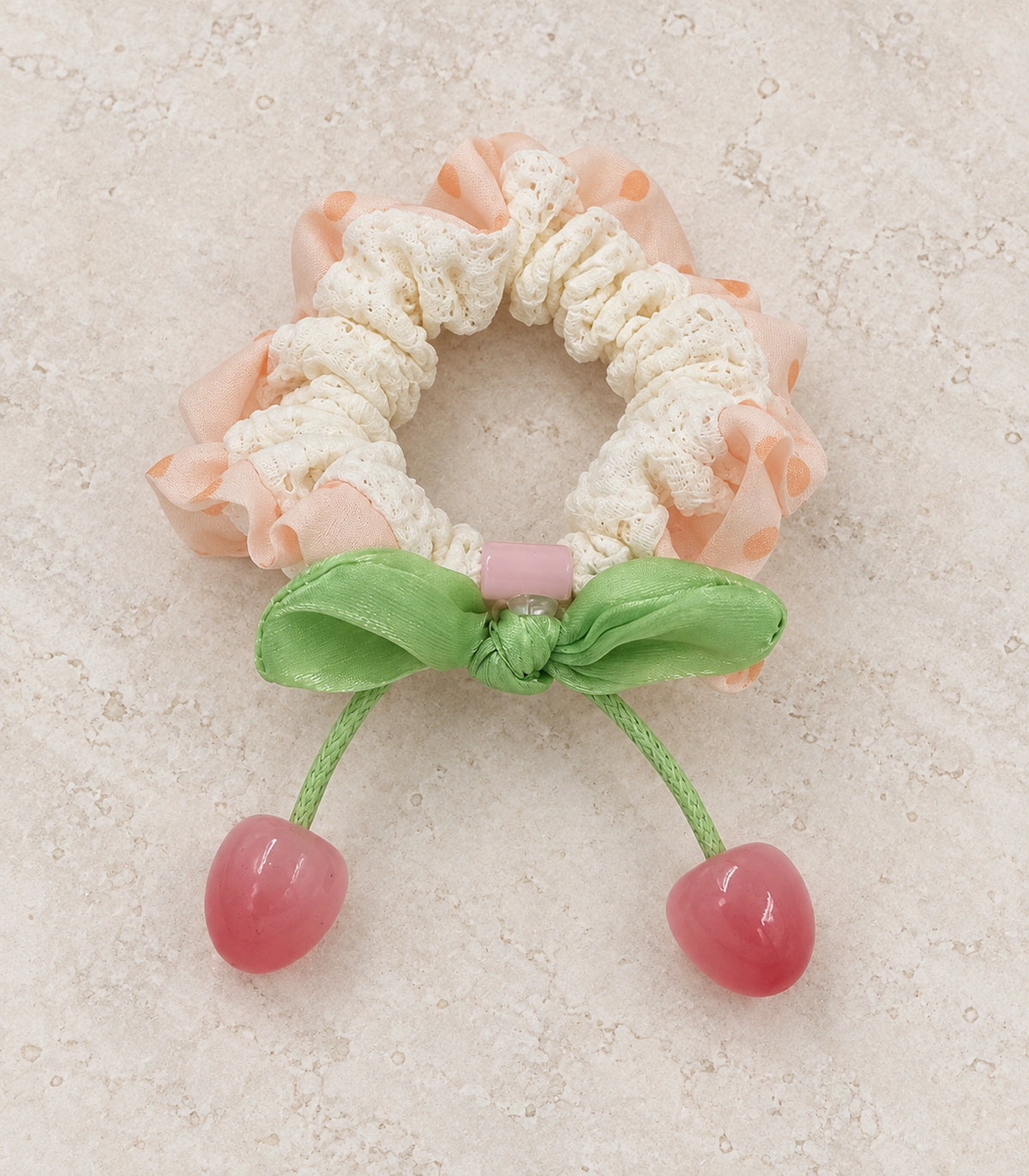 JIMIKI Polka Dot Lace Scrunchie With Cherry Charms in Peach, editorial flat lay #color_peach
