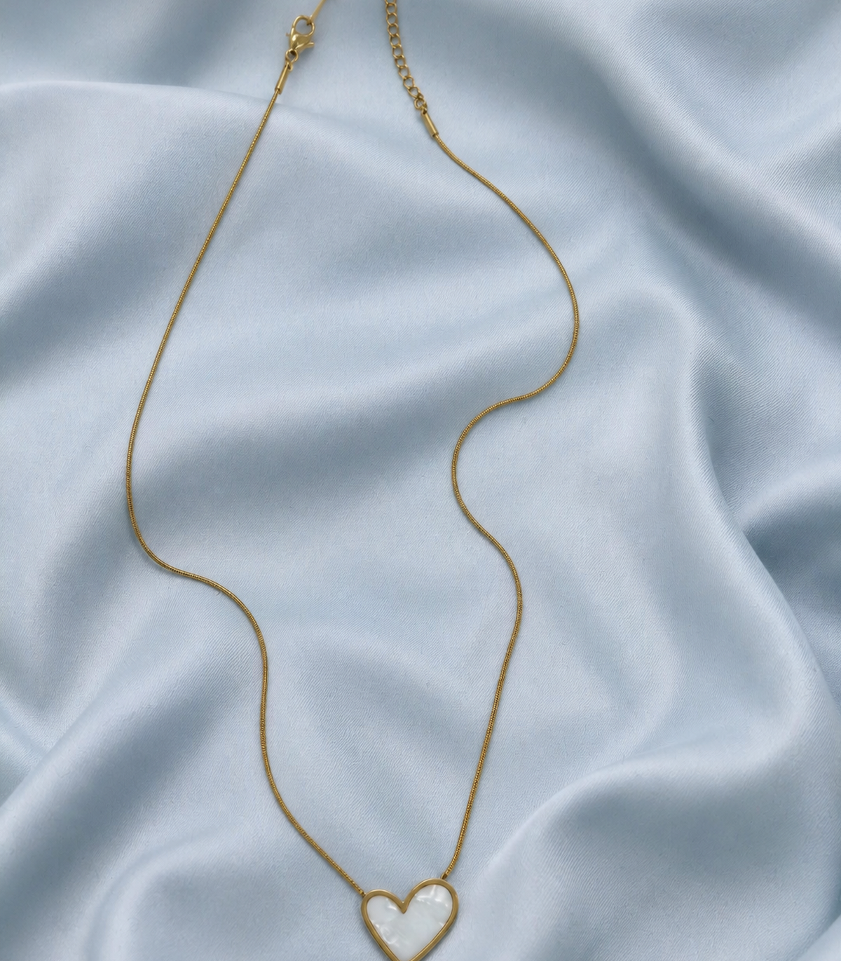 Pearly White Heart Snake Chain Necklace styled in a flat lay