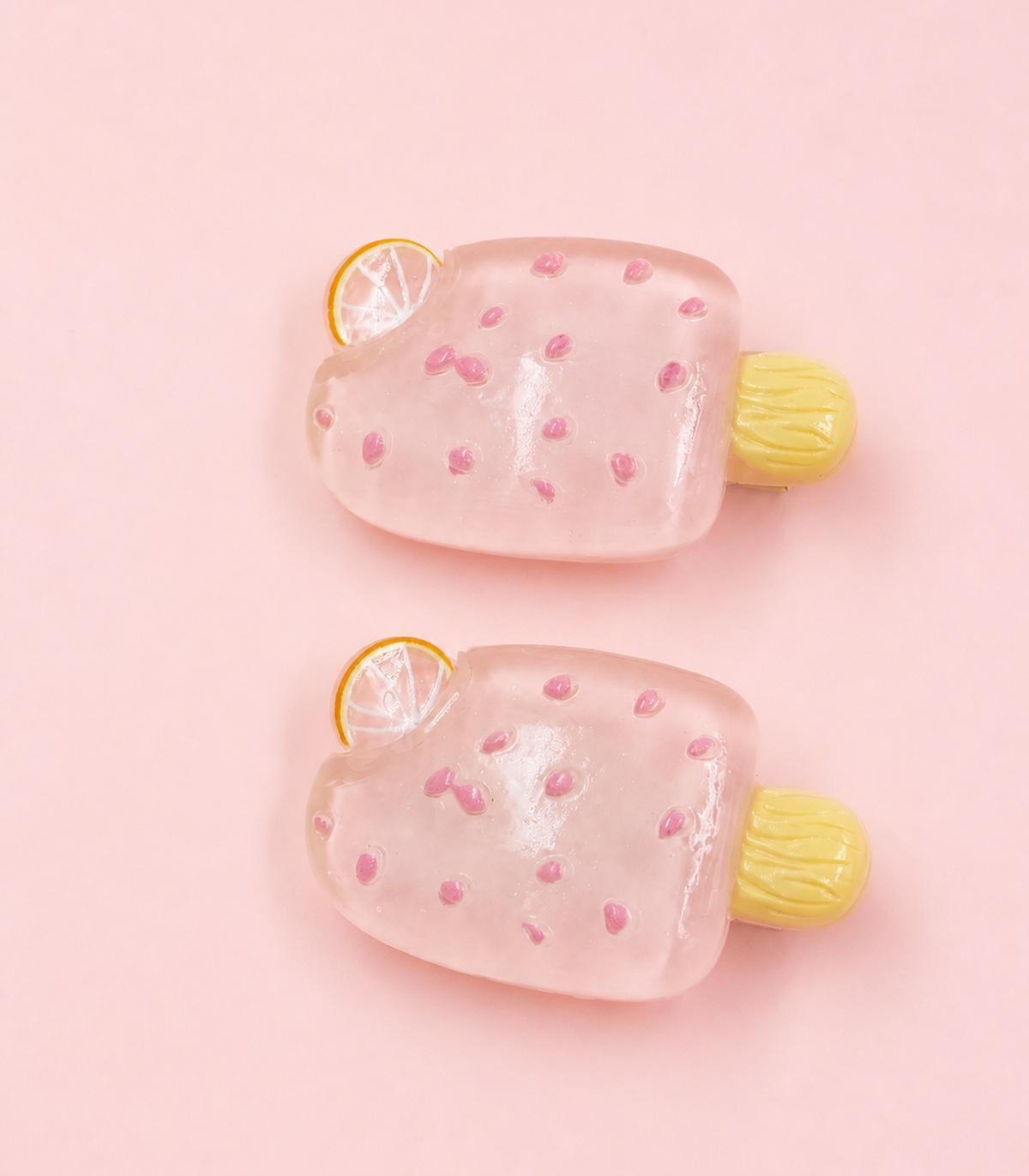 Pink Citrus Ice Pop Barrette Pair editorial flat lay