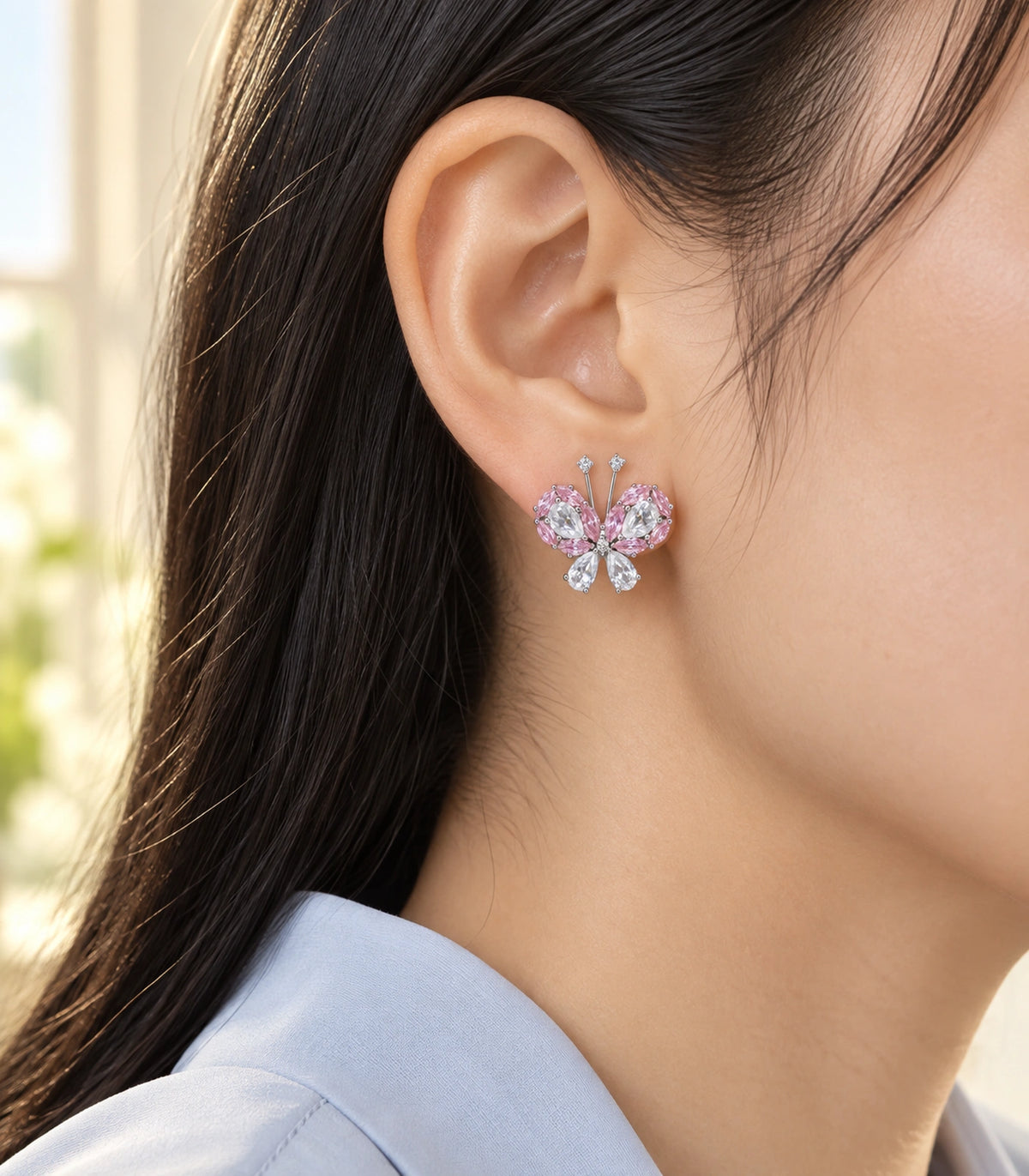 JIMIKI Crystal Butterfly Stud Earring Pair in Pink / silver tone, editorial model view #color_pink / silver tone
