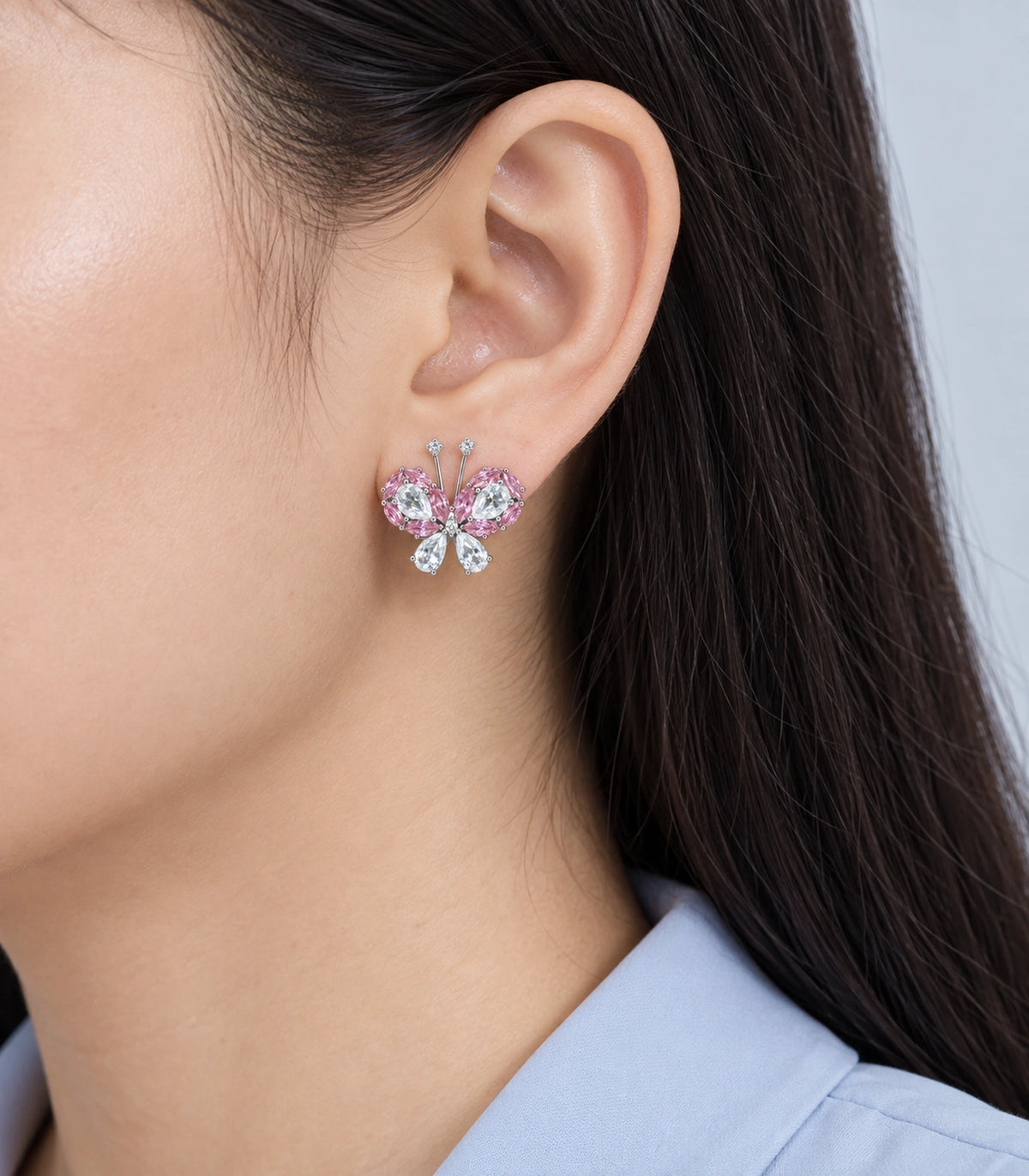 JIMIKI Crystal Butterfly Stud Earring Pair in Pink / silver tone, model wearing view #color_pink / silver tone