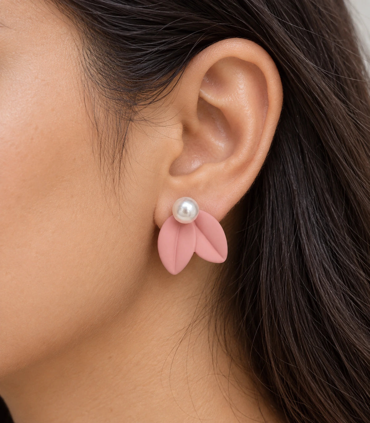 JIMIKI Double Leaf Pearl Stud Earrings in Pink — close-up of the earring worn on the ear #color_pink