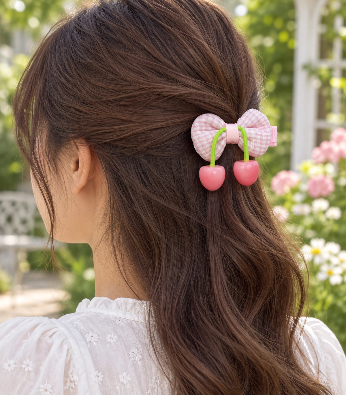 JIMIKI Pink Gingham Bow Hair Clip with Cherry Charms in Pink, editorial model view