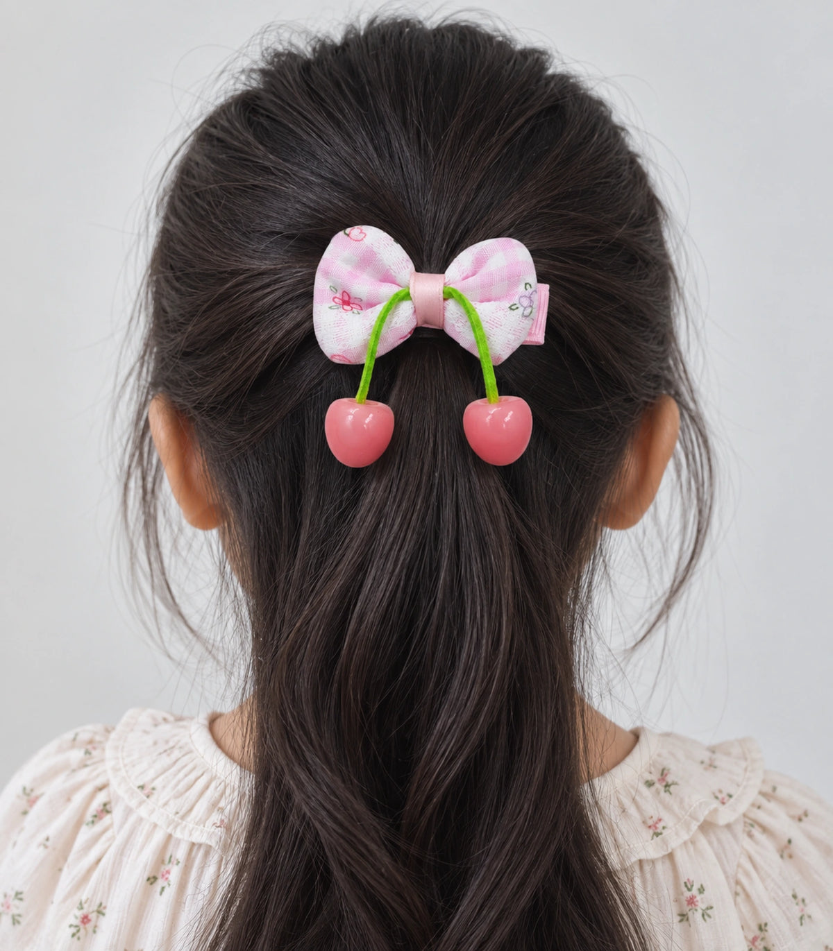 JIMIKI Pink Gingham Floral Bow Hair Clip with Cherry Charms in Pink, model wearing view
