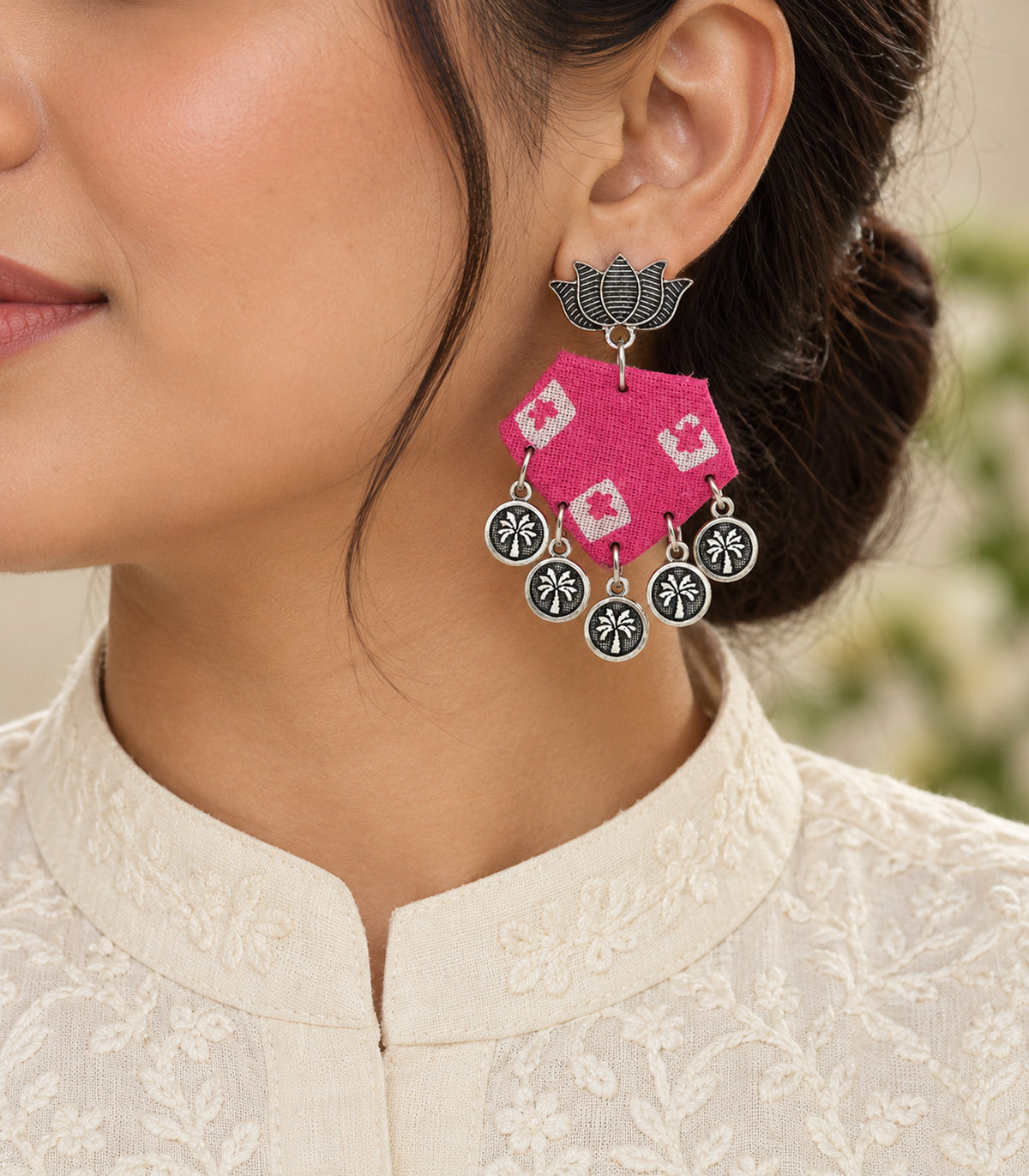Pink and ivory lotus hexagon coin earrings — closeup view