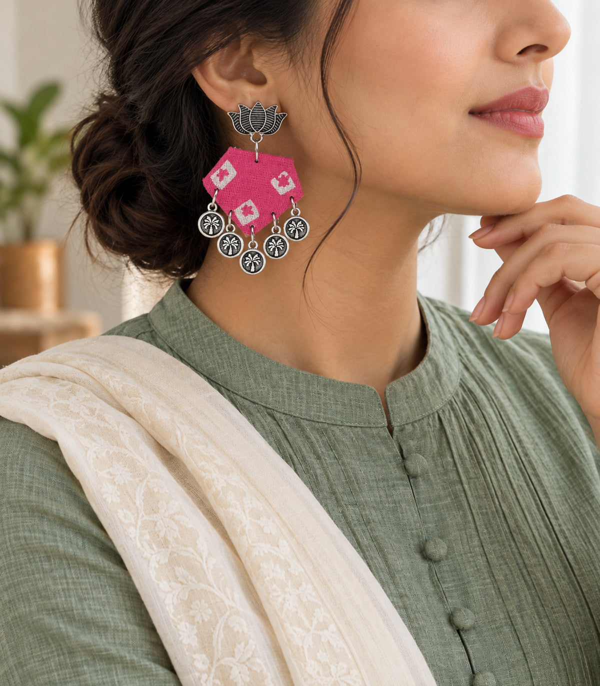 Pink and ivory lotus hexagon coin earrings — editorial model view