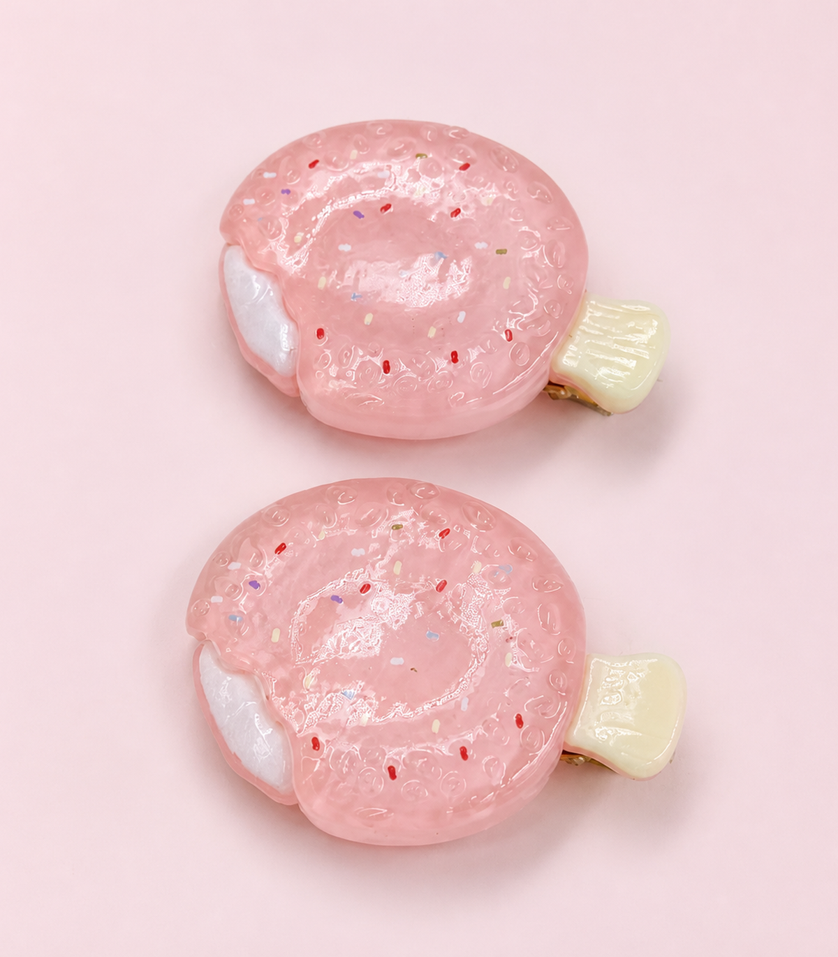 Pink Swirled Pastry Barrette Pair editorial flat lay