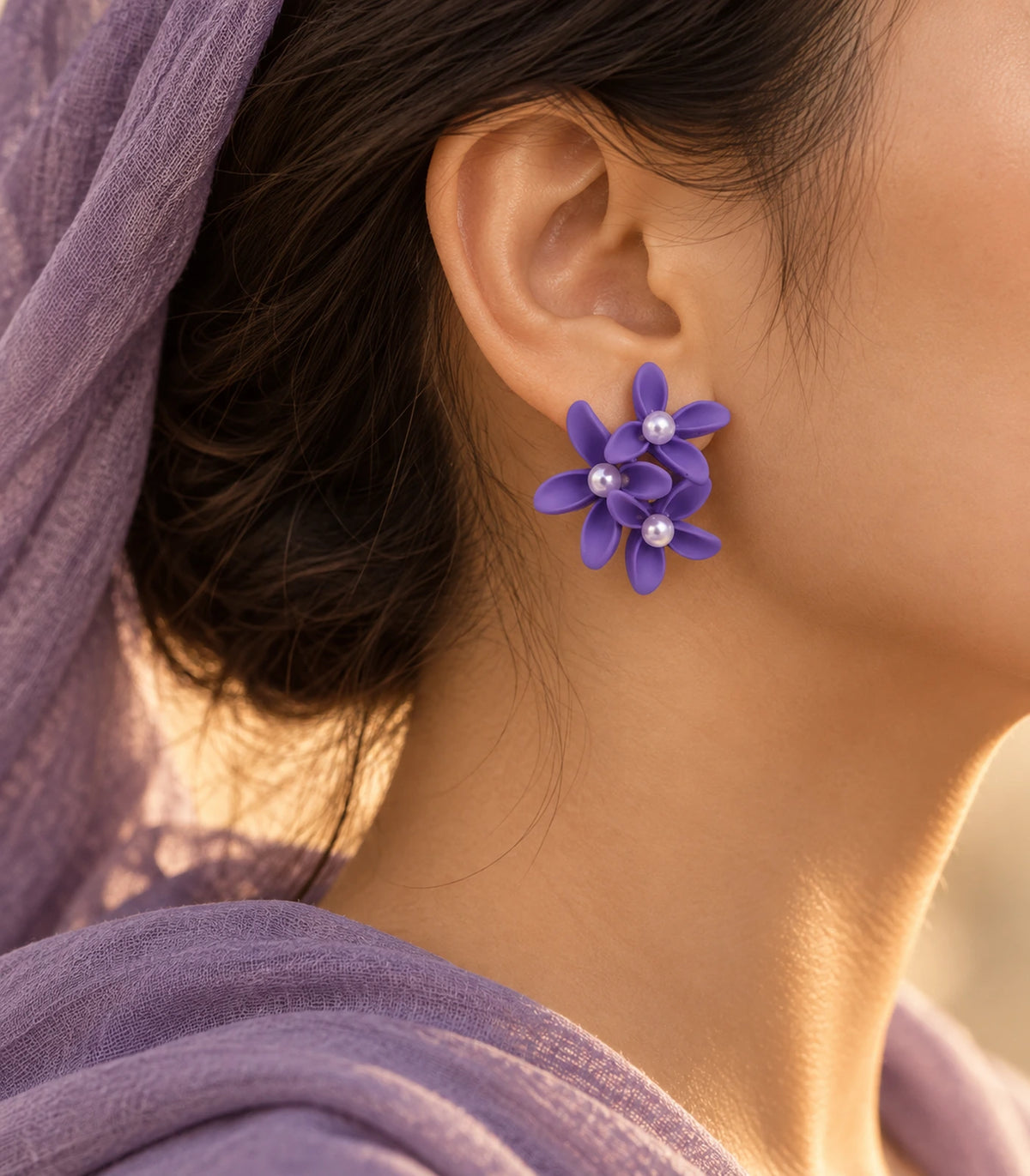 JIMIKI Purple cascading floral cluster stud earrings, worn with softly lit editorial styling #color_purple