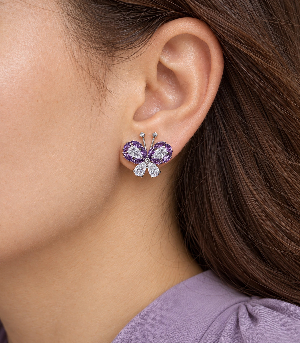 JIMIKI Crystal Butterfly Stud Earring Pair in Purple / silver tone, close-up detail #color_purple / silver tone