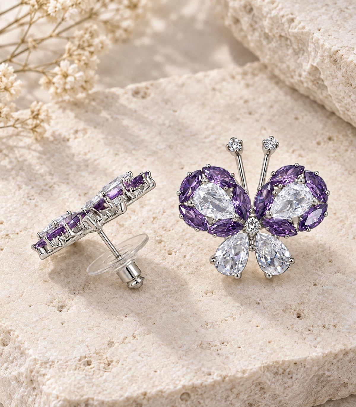JIMIKI Crystal Butterfly Stud Earring Pair in Purple / silver tone, editorial flat lay #color_purple / silver tone