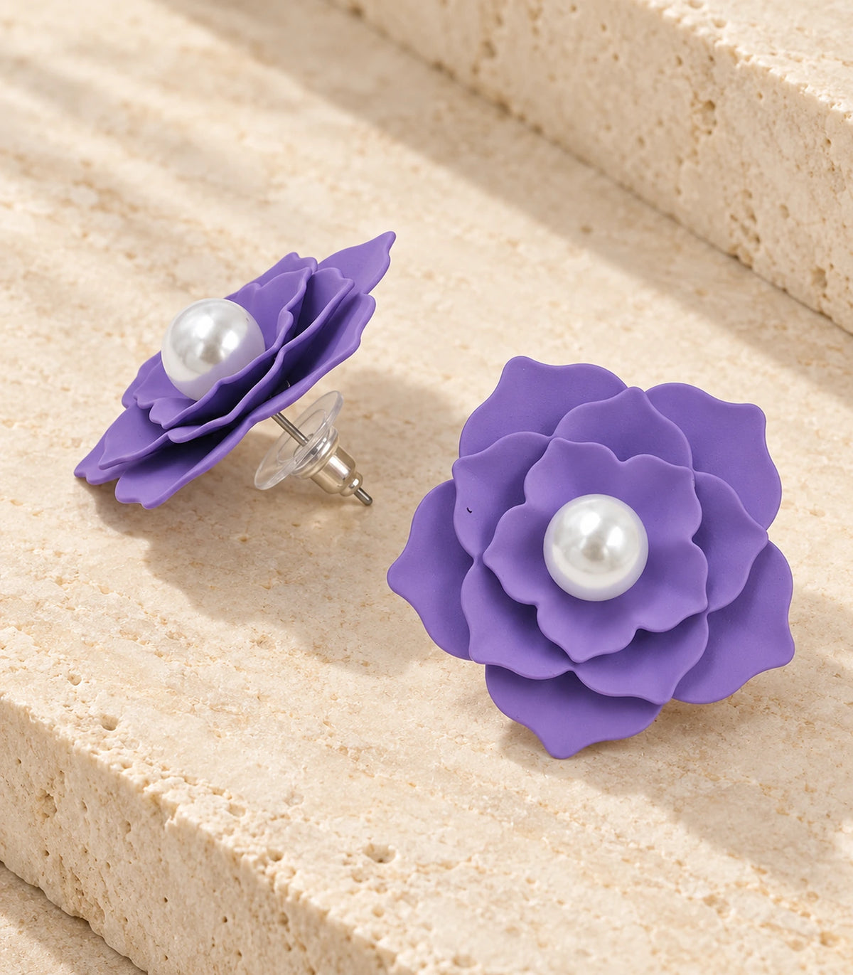 JIMIKI Layered Flower Pearl Stud Earrings, Purple — pair in a styled flat lay #color_purple