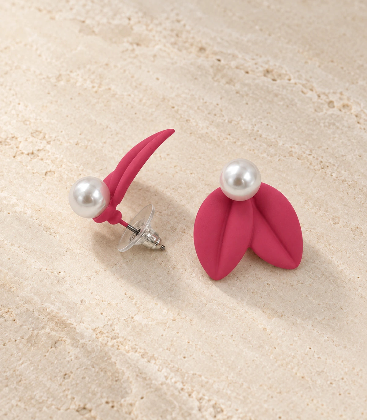 JIMIKI Double Leaf Pearl Stud Earrings in Raspberry Pink — pair in a styled flat lay #color_raspberry pink