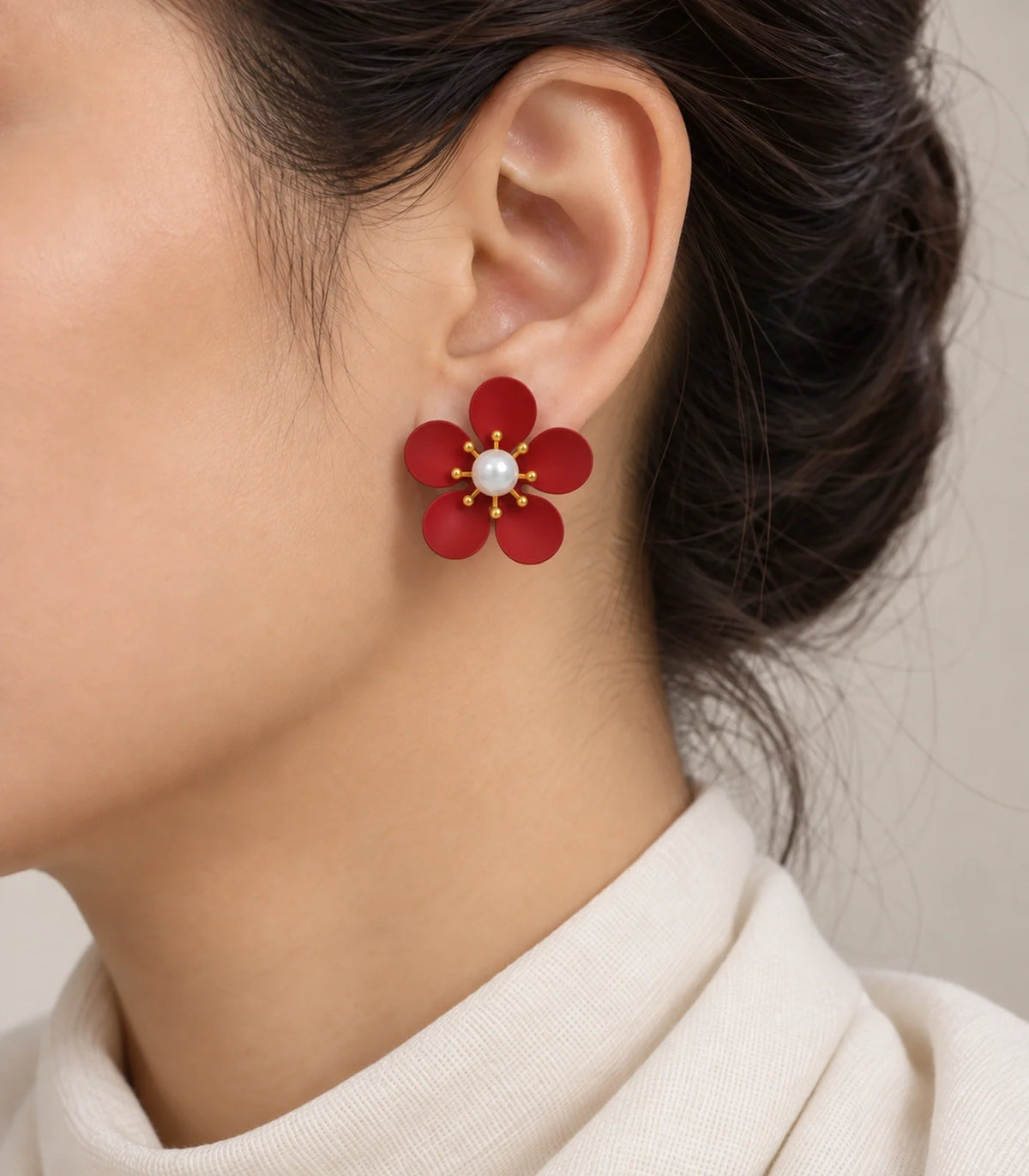 Red five-petal pearl flower stud earrings worn on model