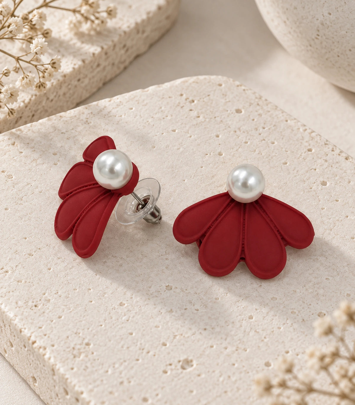 JIMIKI Red pearl fan petal stud earrings, pair in an editorial flat lay #color_red