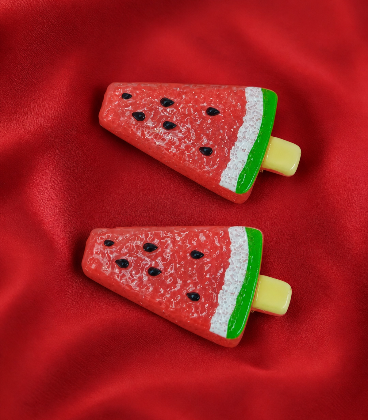 Red Watermelon Barrette Pair editorial flat lay