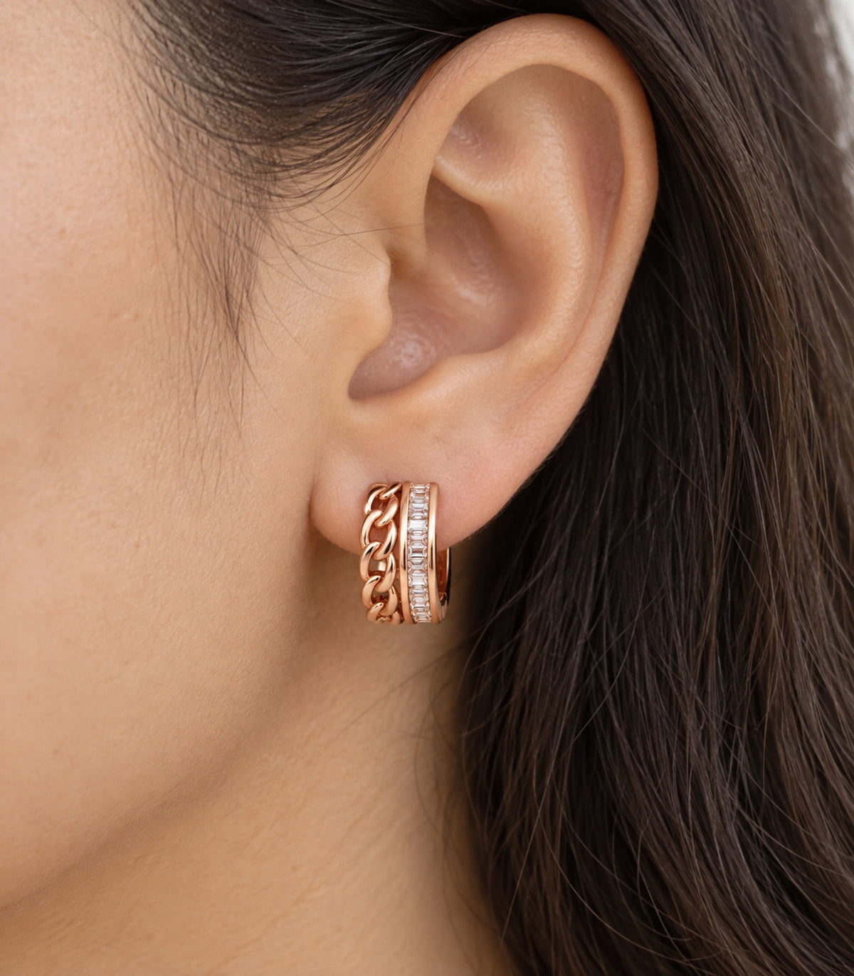 JIMIKI rose gold baguette chain double row huggie earrings, worn closeup of the front design #color_rose-gold-tone