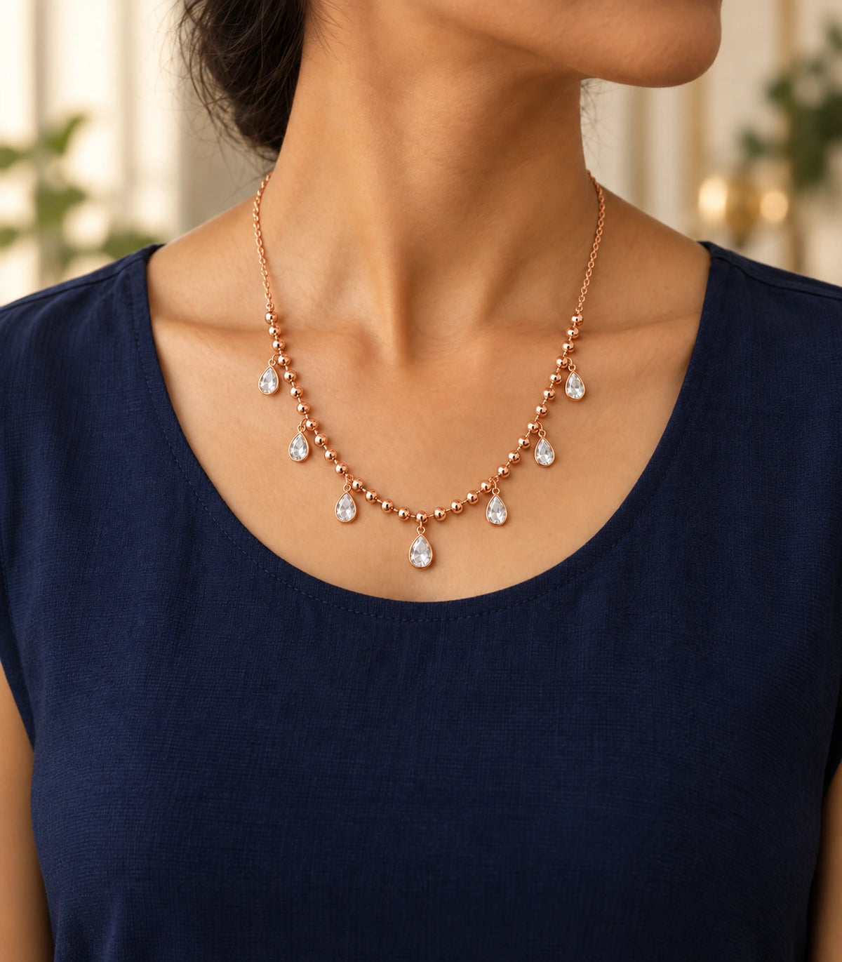 JIMIKI Rose-Gold Bead and Pear-Crystal Drop Necklace in Rose Gold - editorial worn view #color_rose-gold
