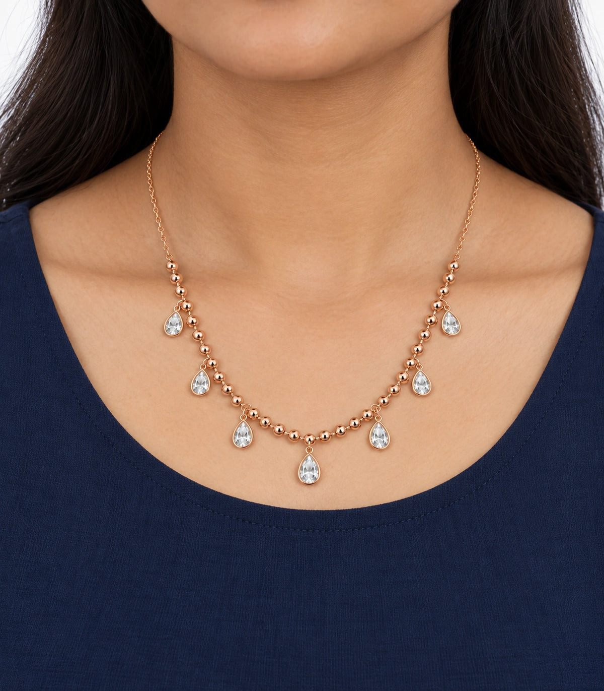 JIMIKI Rose-Gold Bead and Pear-Crystal Drop Necklace in Rose Gold - worn styling view #color_rose-gold