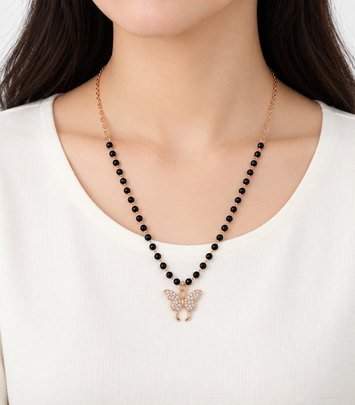 JIMIKI Rose-Gold Black-Bead Crystal Butterfly Necklace in Rose Gold / Black - worn styling view #color_rose-gold-black
