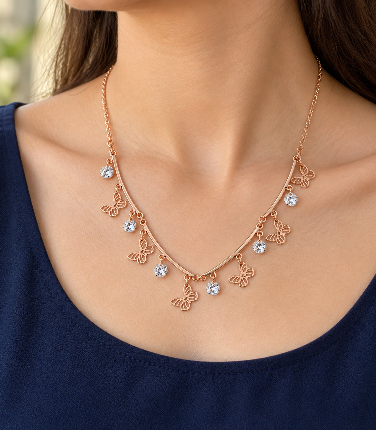 JIMIKI Rose Gold Butterfly Crystal Charm Collar Necklace in Rose Gold - editorial worn view #color_rose-gold