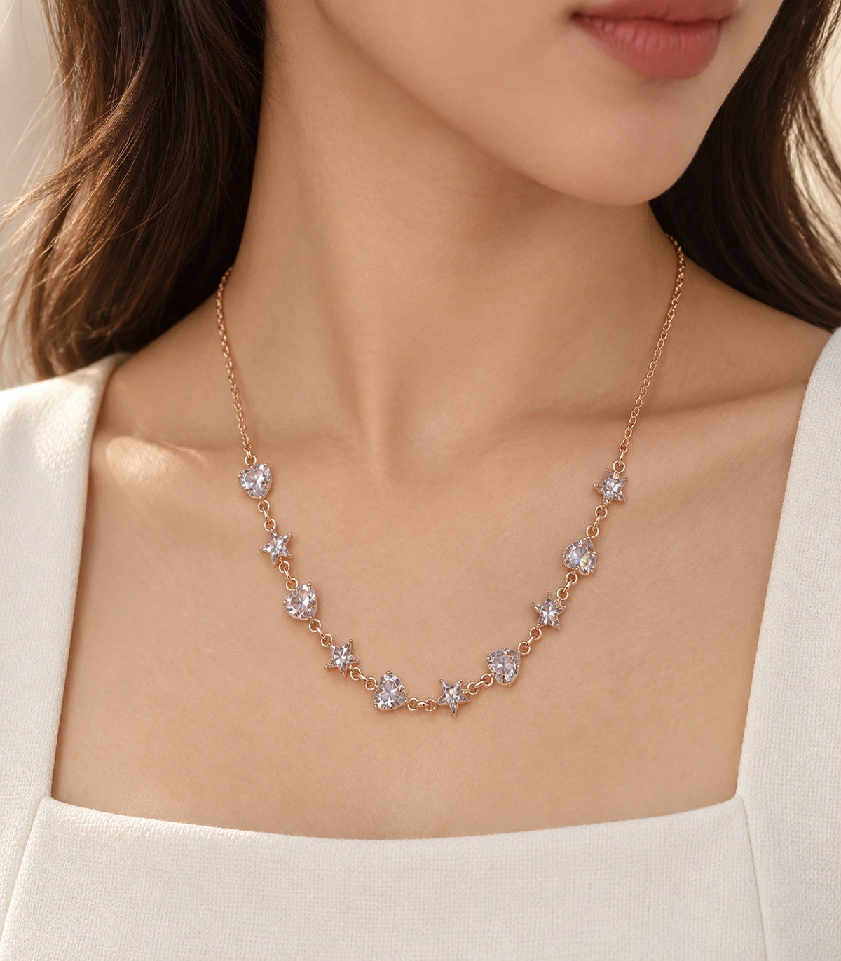 JIMIKI Rose Gold Crystal Heart Star Station Necklace - heart and star necklace in an editorial worn view #color_rose-gold