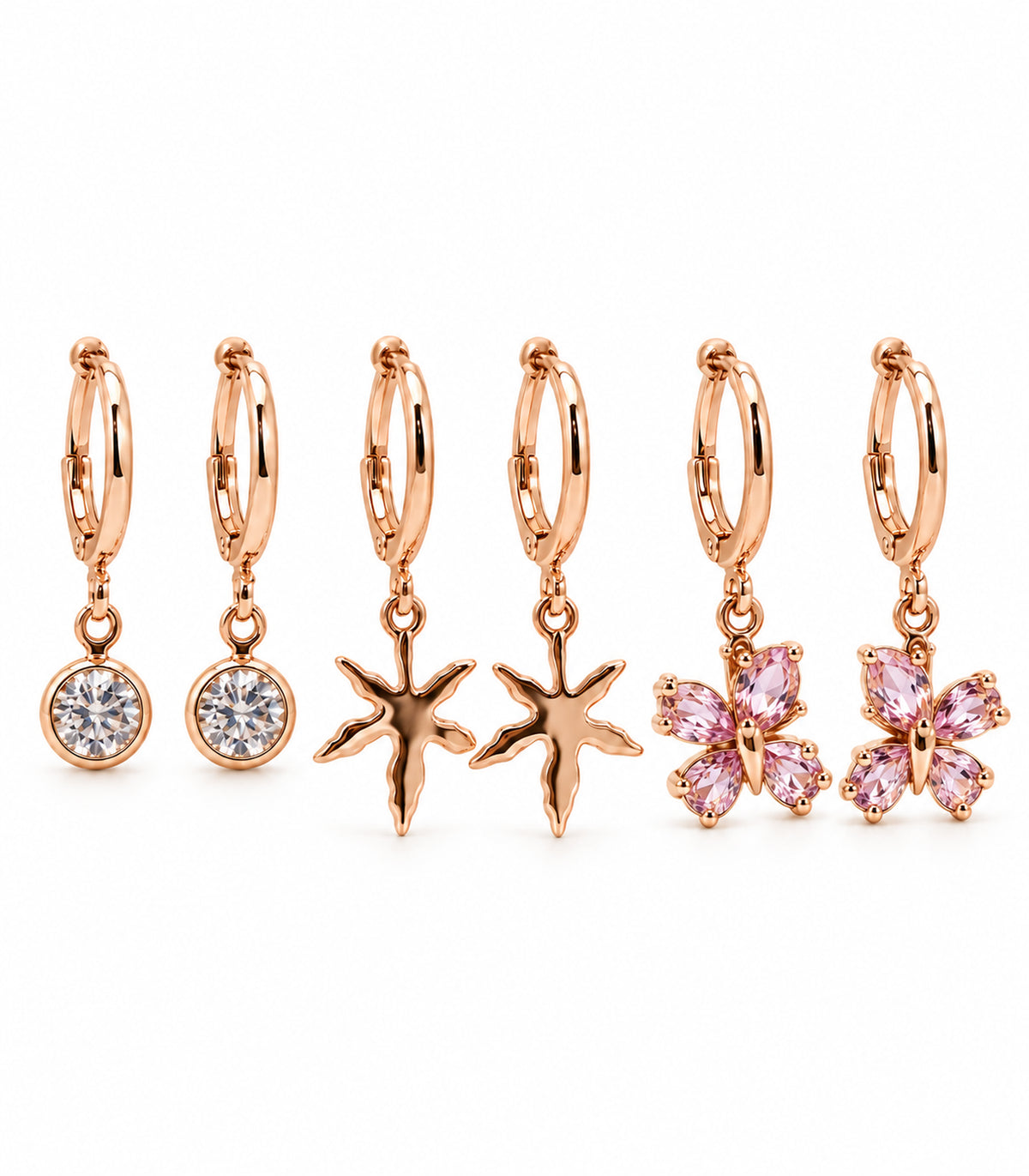 Complete rose gold tone six-earring set: crystal drops, five-arm starfish and four-stone pink butterfly hoops on white