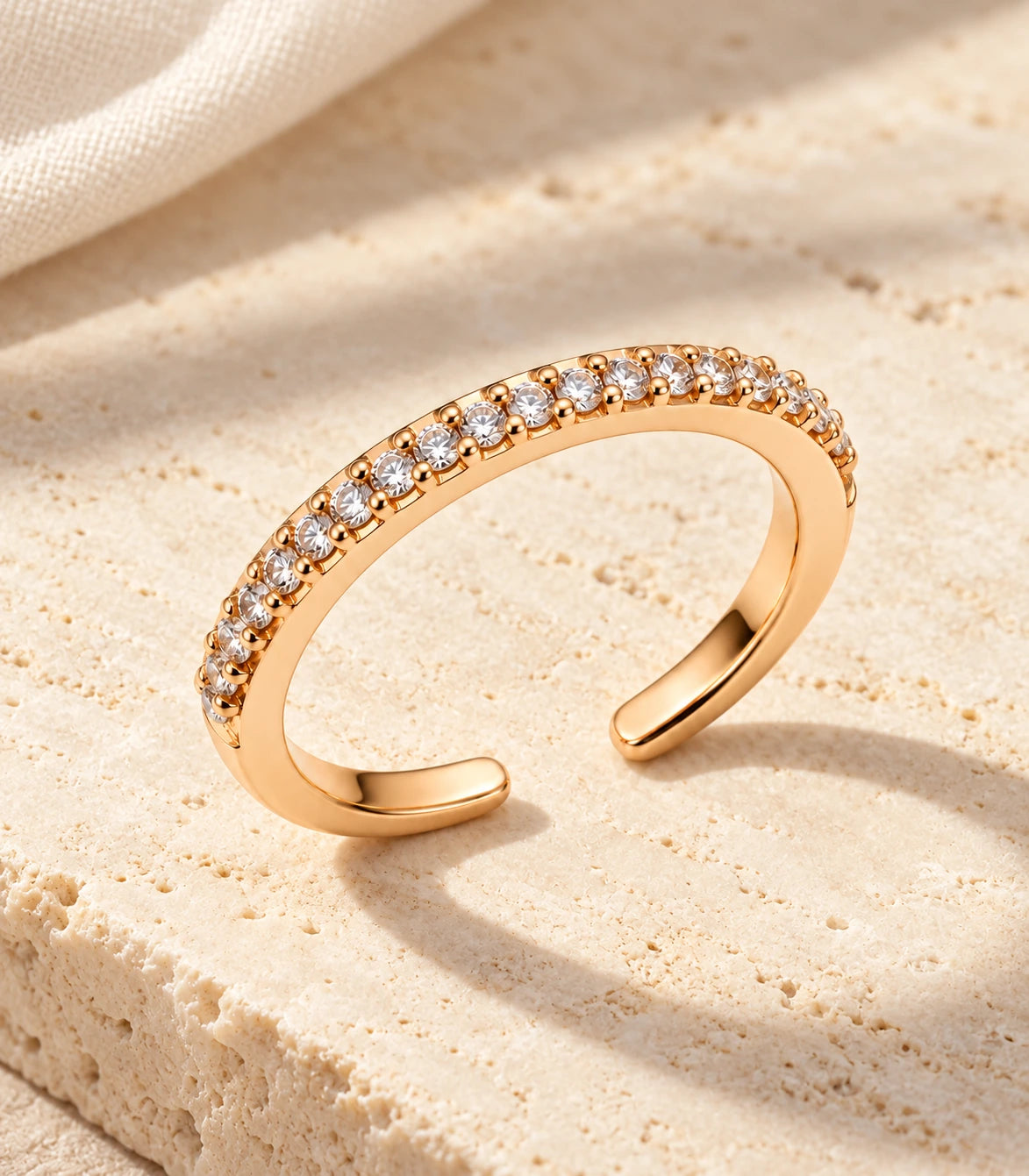 JIMIKI Rose Gold Curved Crystal Row Adjustable Ring in Rose Gold - editorial flatlay #color_rose-gold