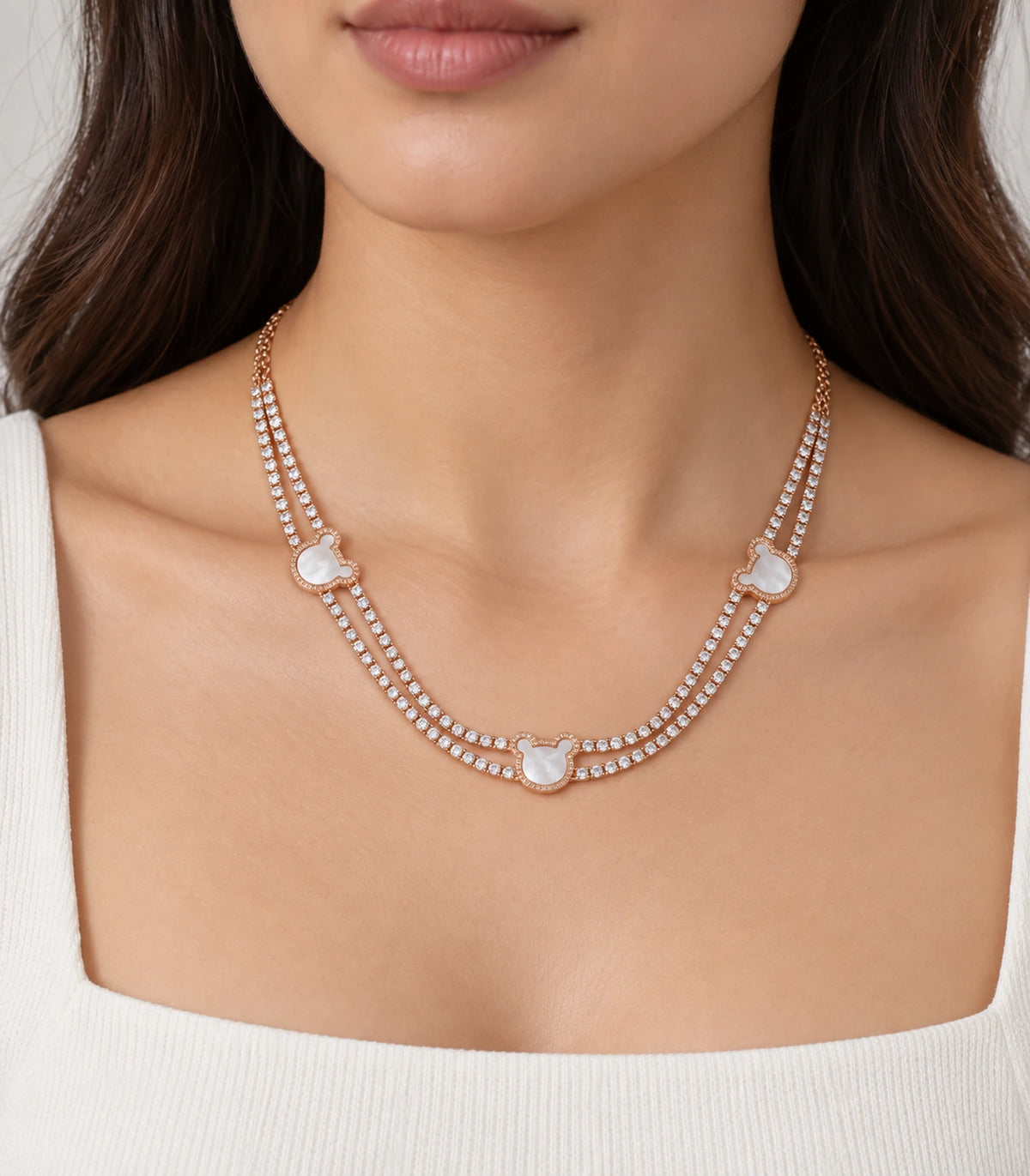 JIMIKI rose-gold-tone double-strand motif necklace, double strands and three motifs shown worn at the neckline #color_rose gold