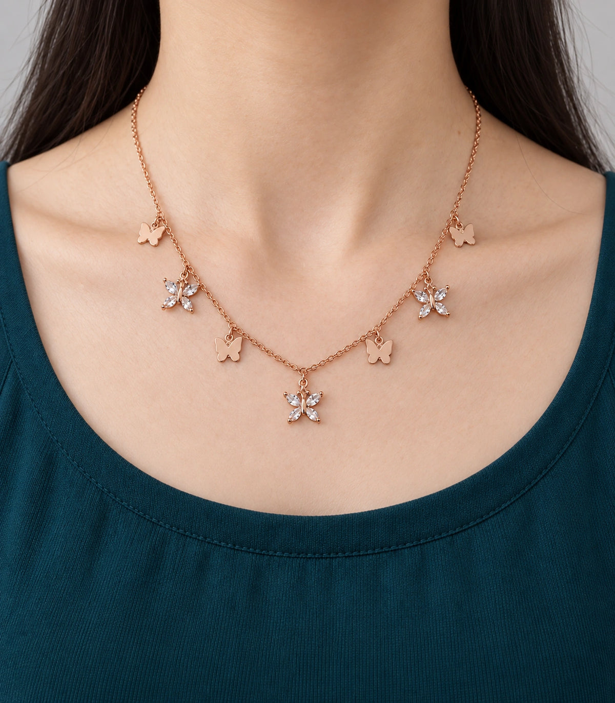 JIMIKI Rose Gold Mixed Butterfly Charm Necklace in Rose Gold - worn styling view #color_rose-gold
