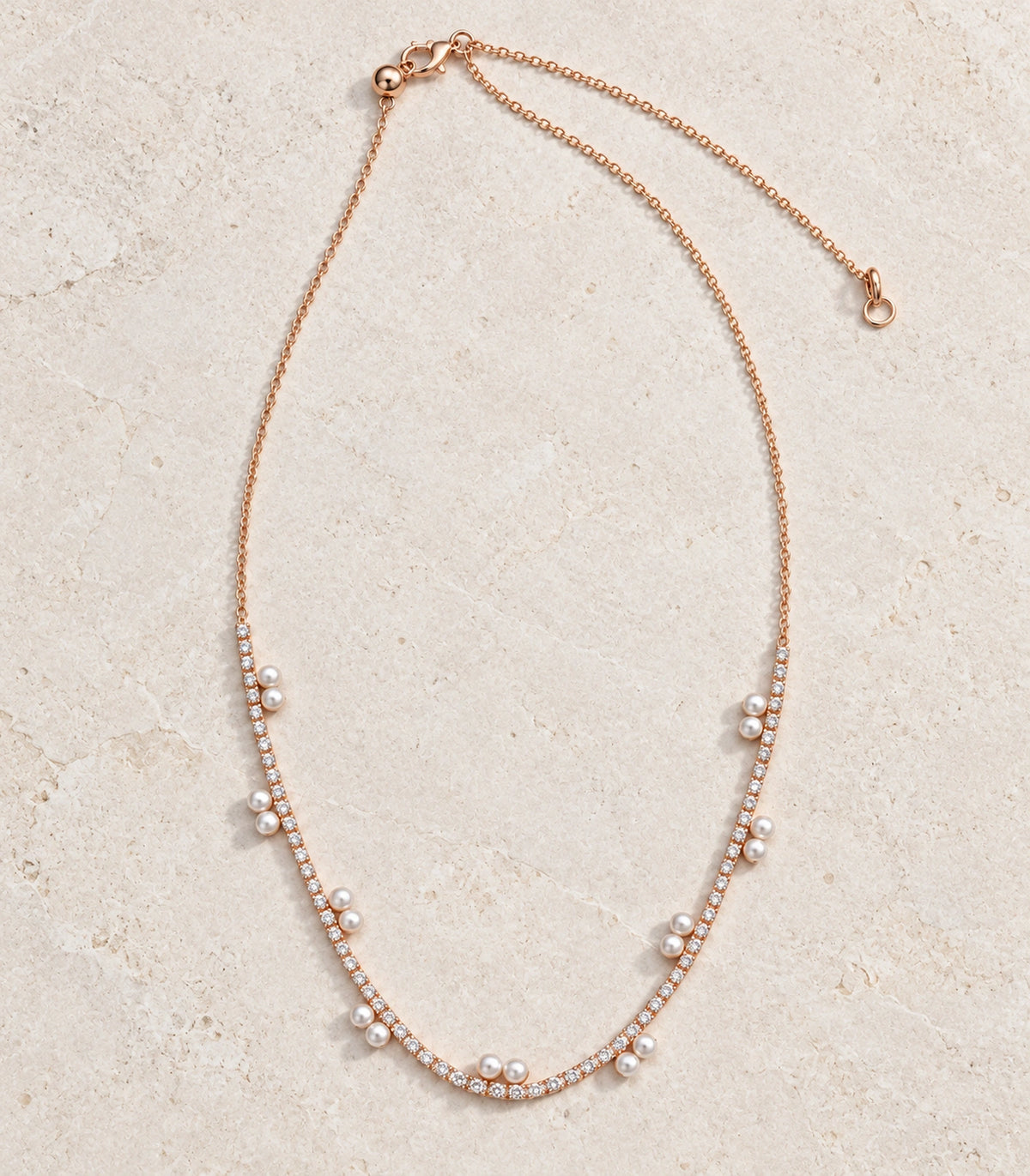 JIMIKI Rose Gold Paired Pearl Crystal Tennis Necklace in Rose Gold - editorial flatlay #color_rose-gold