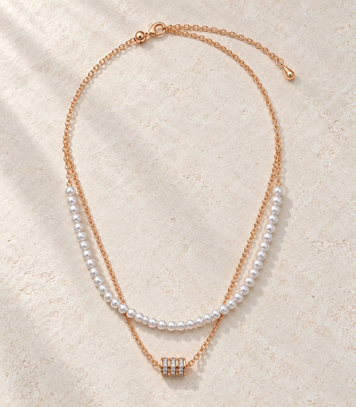 JIMIKI Rose-Gold Pearl and Crystal-Barrel Layered Necklace in Rose Gold - editorial flatlay #color_rose-gold