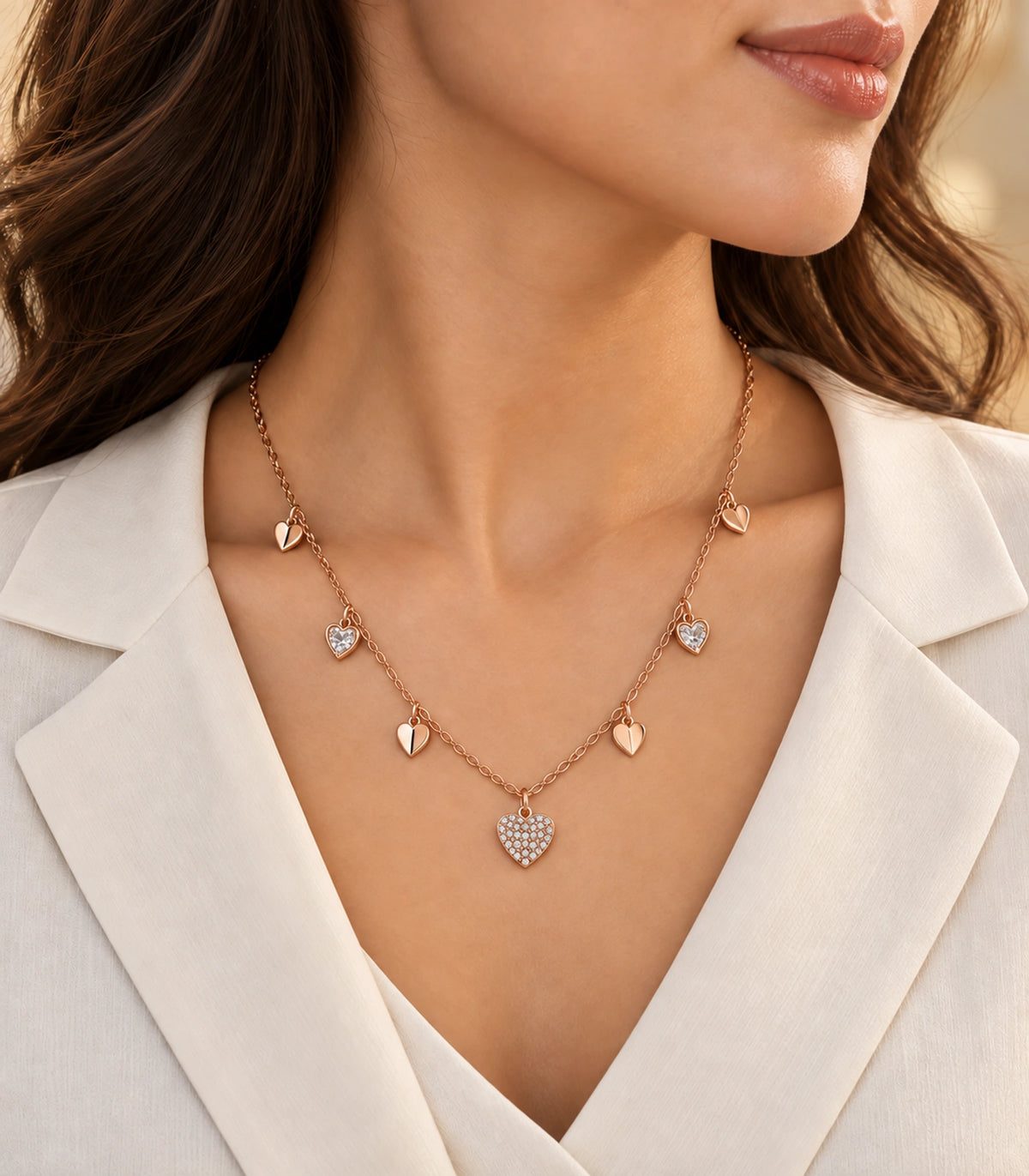 JIMIKI rose gold-tone seven heart charm necklace, alternate worn view of the rose gold-tone seven-heart necklace #color_rose-gold
