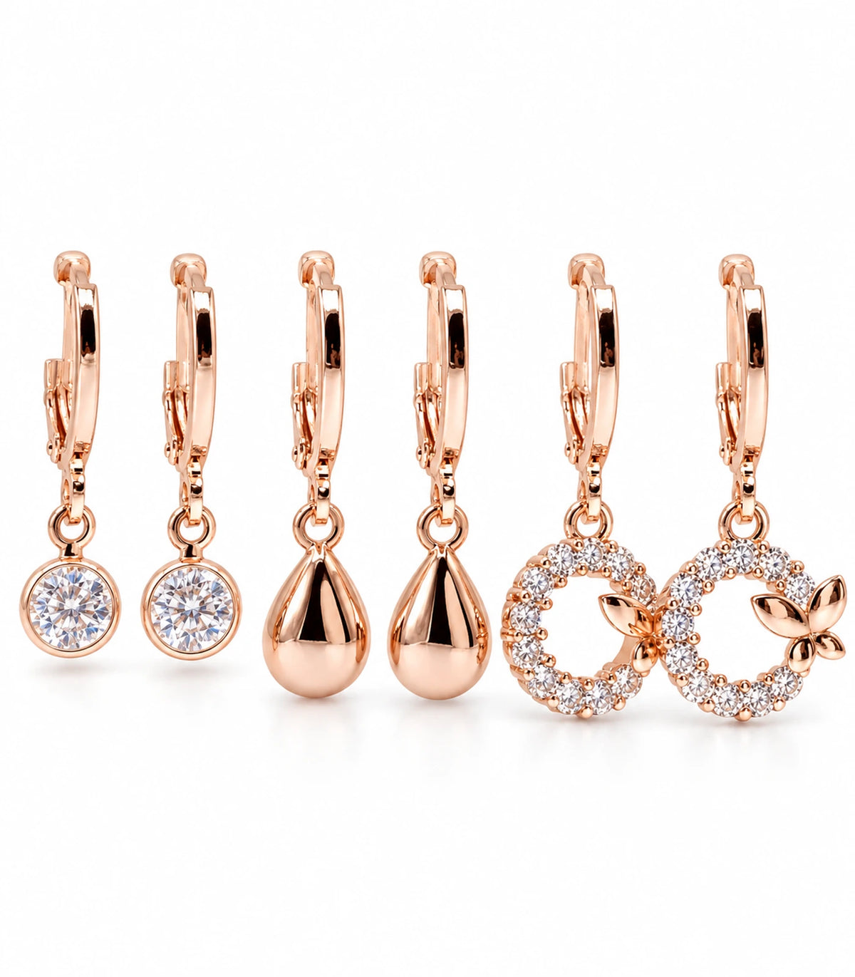 Complete rose gold tone three-pair hoop earring set: clear crystals, puffed teardrops and four-leaf crystal wreaths, six earrings