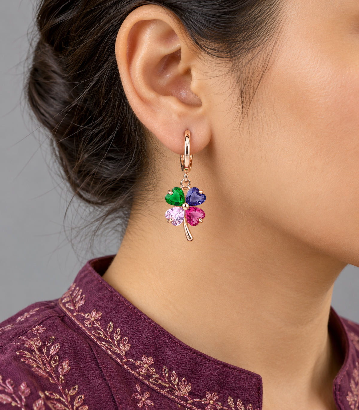 Four-colour clover charm hoop from the set shown worn in closeup #Color_Rose Gold Tone