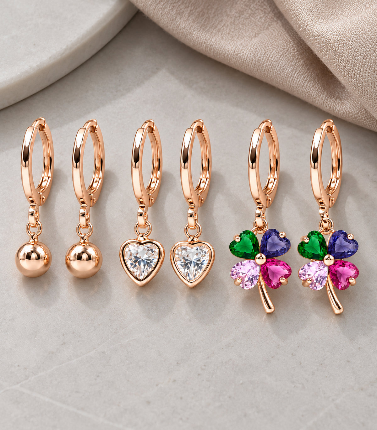 Complete six-earring set arranged as ball, clear heart and multicolour clover pairs #Color_Rose Gold Tone