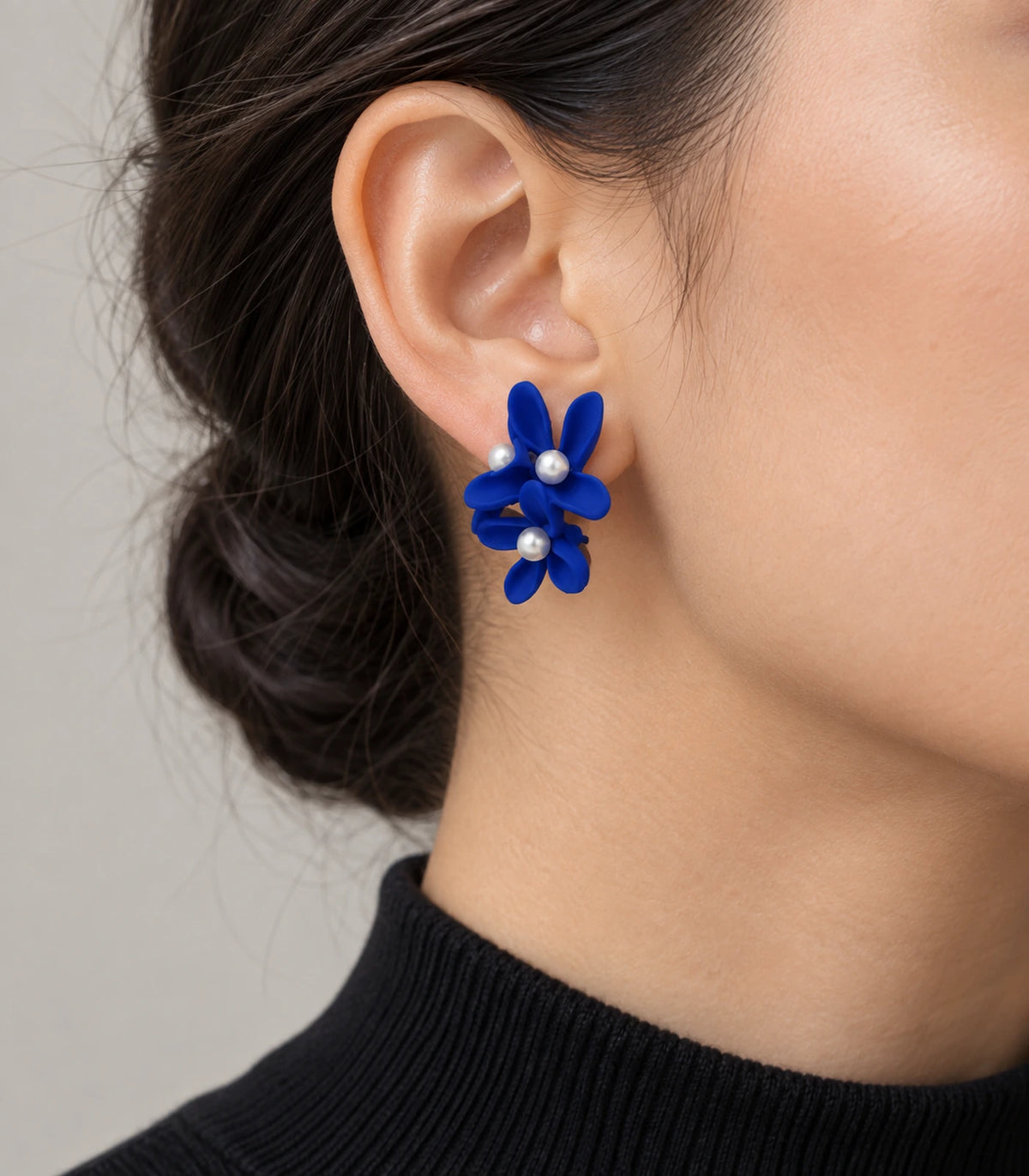 JIMIKI Royal Blue cascading floral cluster stud earrings, worn on the ear with the floral cluster visible #color_royal blue