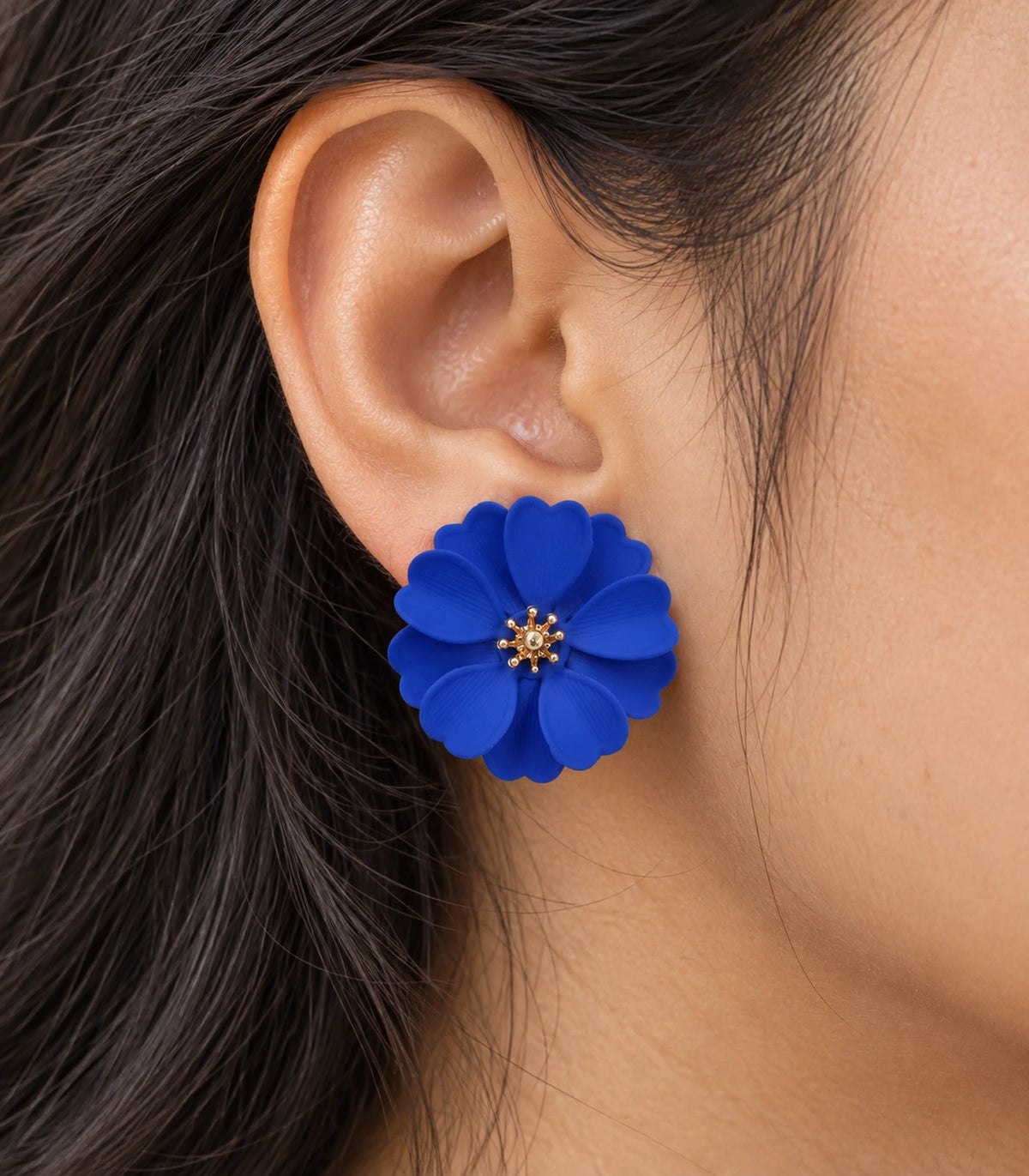 JIMIKI Royal Blue Layered Daisy Stud Earrings - layered scalloped petals and gold-tone centre worn close-up #color_royal blue
