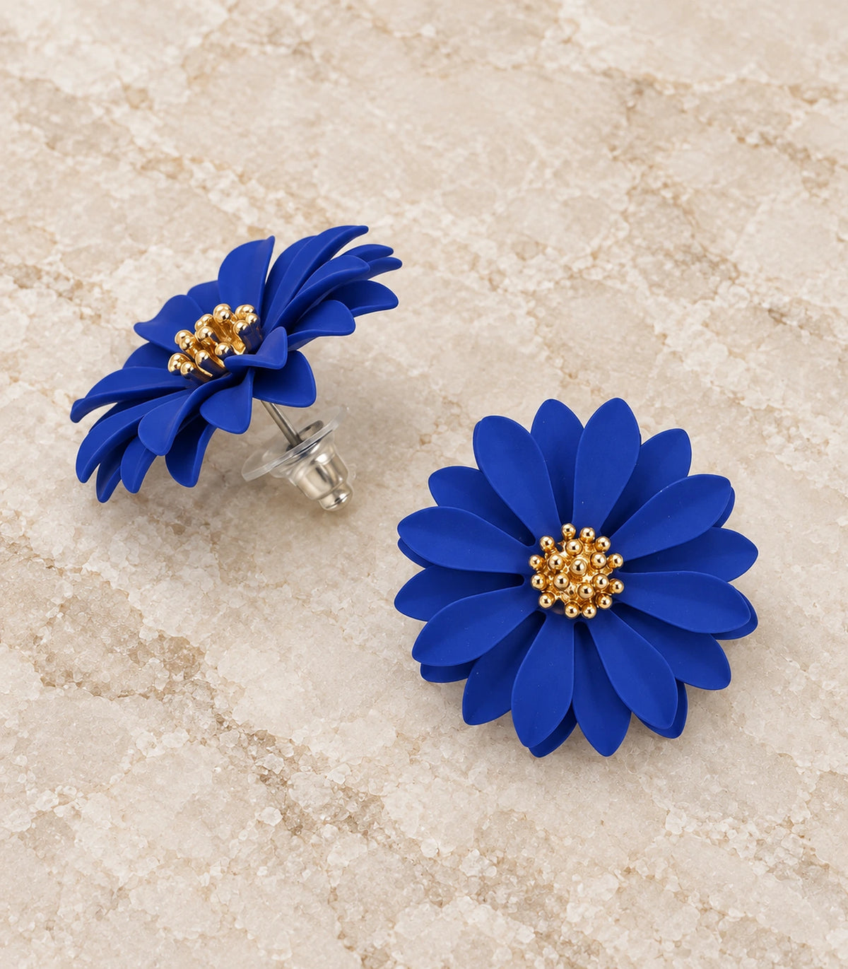 JIMIKI Royal Blue layered starburst daisy stud earrings, matching pair in a styled flat lay #color_royal blue
