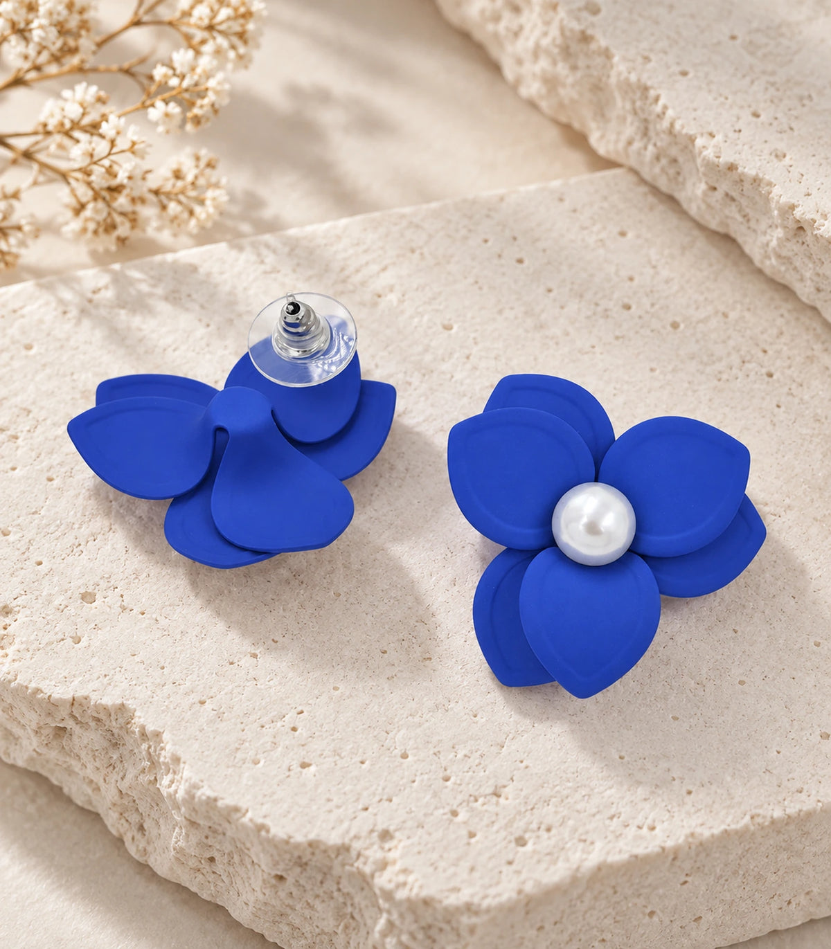 JIMIKI Royal Blue Triple Petal Pearl Flower Stud Earrings - pair in styled flat lay #color_royal blue