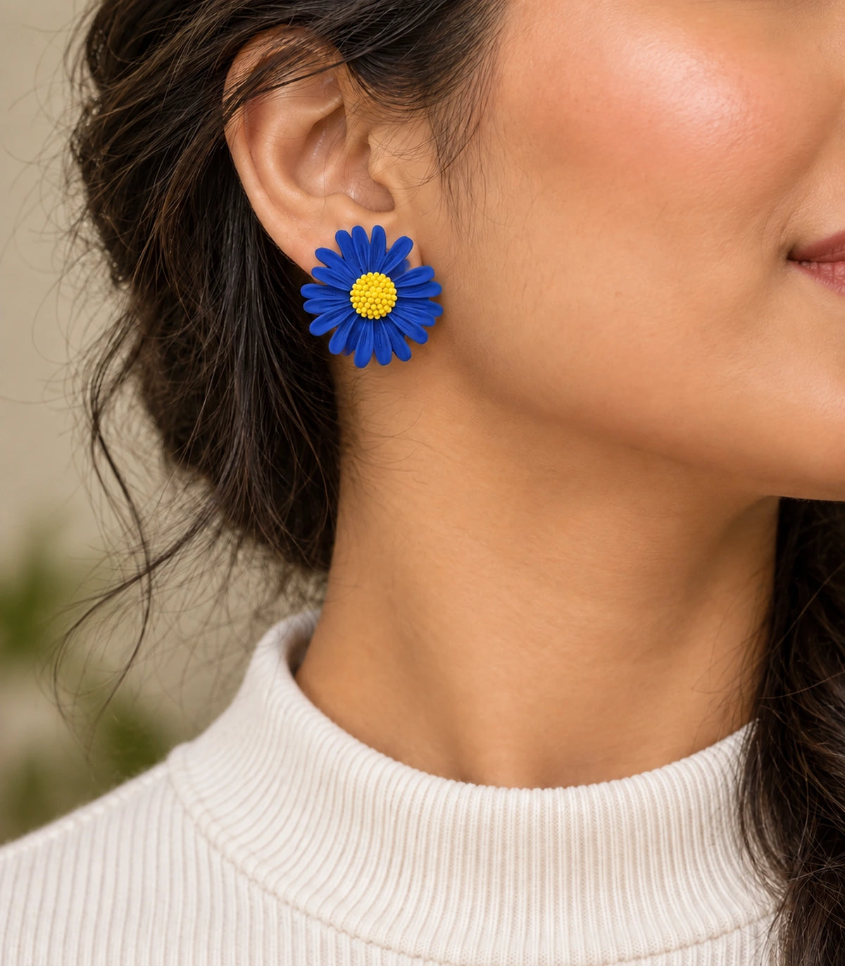 JIMIKI Royal Blue yellow centre daisy stud earrings, earring worn in a warm editorial setting #color_royal blue