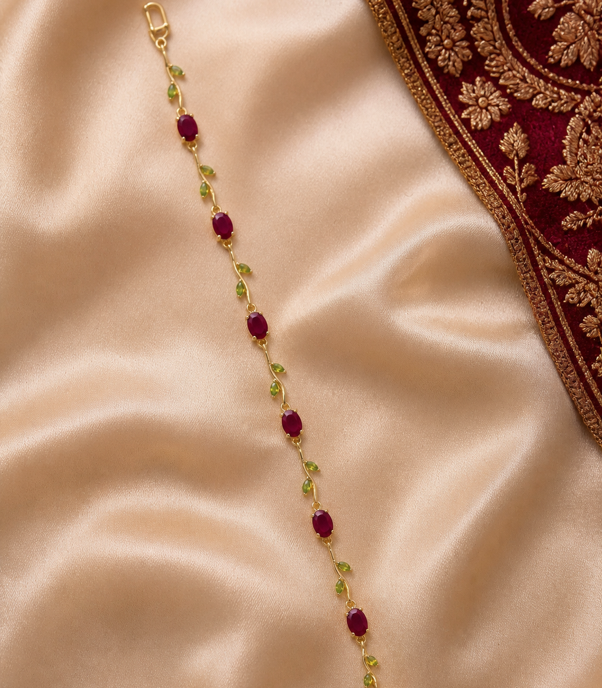 Ruby Red & Green Leaf Vine Bracelet in an editorial flat lay