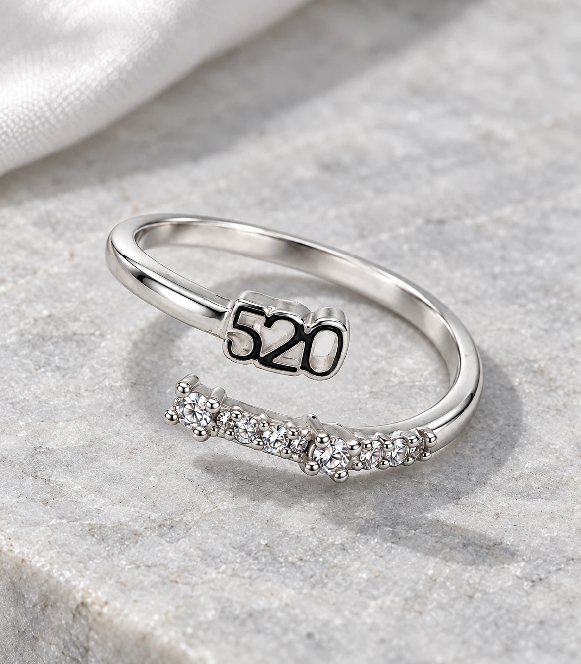 JIMIKI Silver 520 Crystal Bypass Adjustable Ring in Silver - editorial flatlay #color_silver