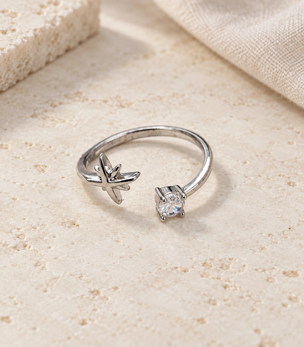 JIMIKI Silver Airplane and Round Crystal Adjustable Ring in Silver - editorial flatlay #color_silver